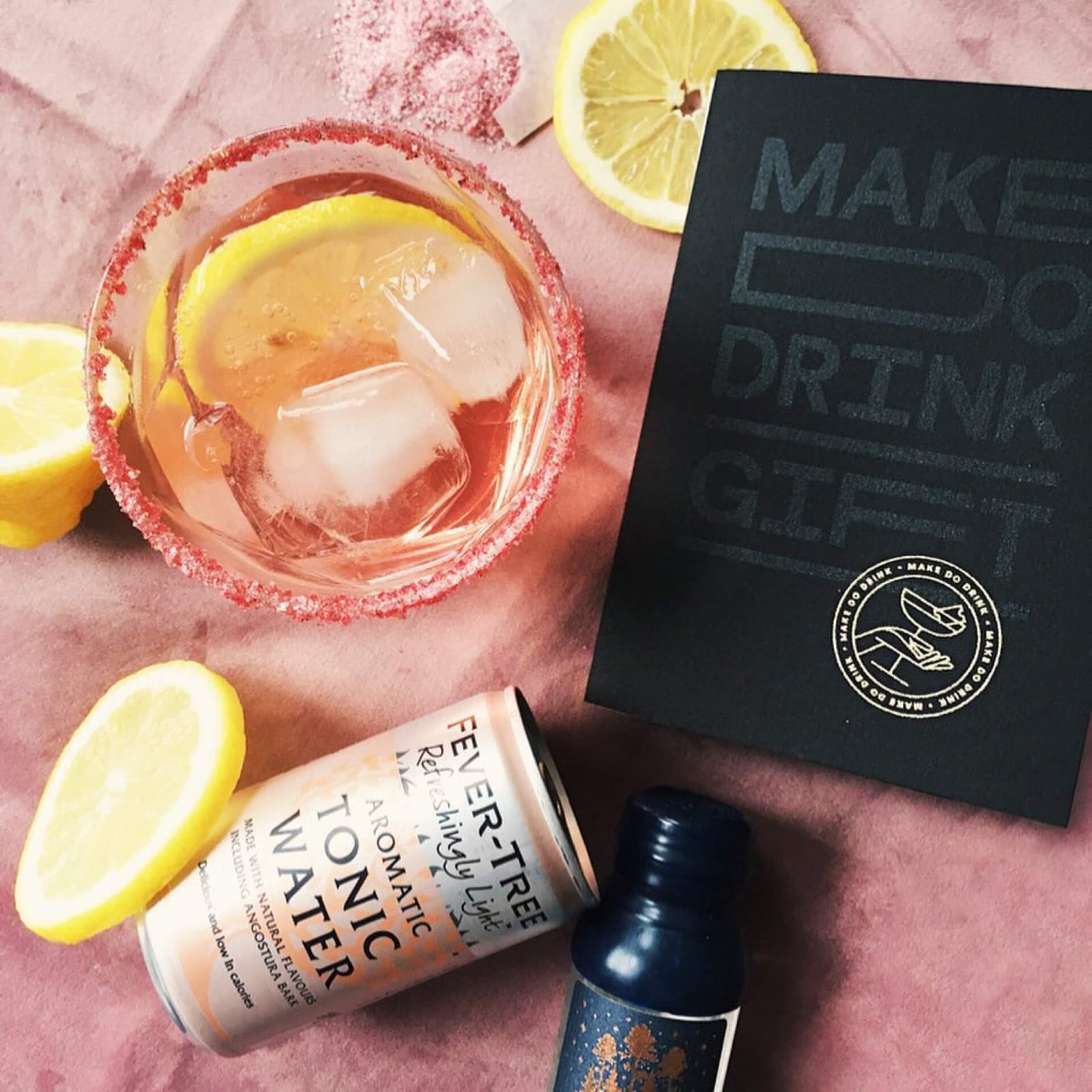 cocktail ingredients on a pink velvet background