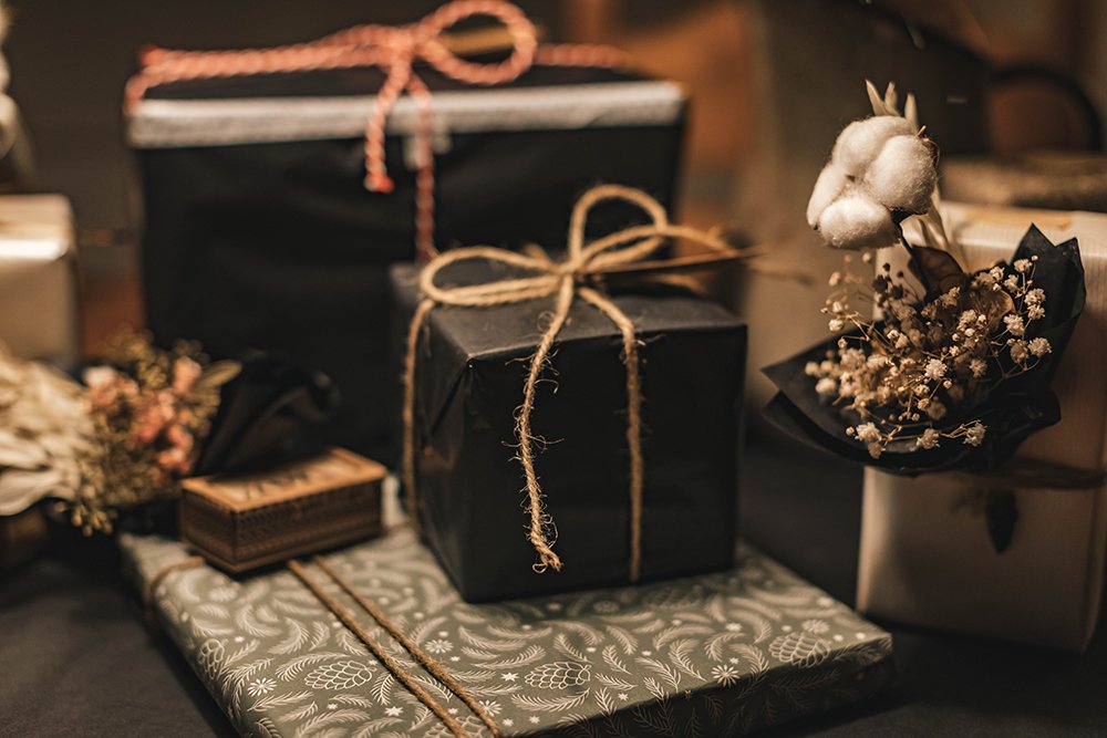 gifts wrapped in black paper and twine