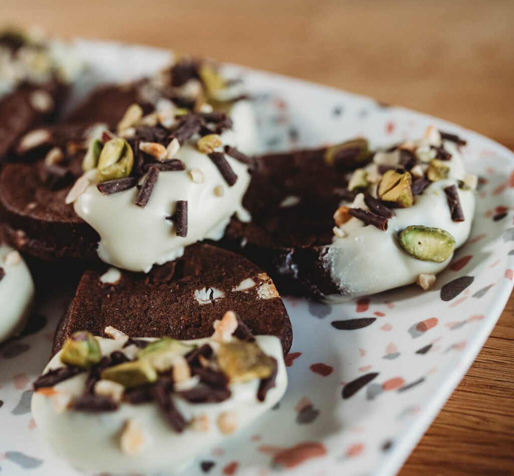 chocolate brownie cookies dipped in white chocolate and pistachios